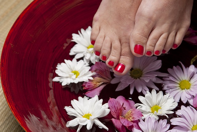 A basin with flowers and a feet. 